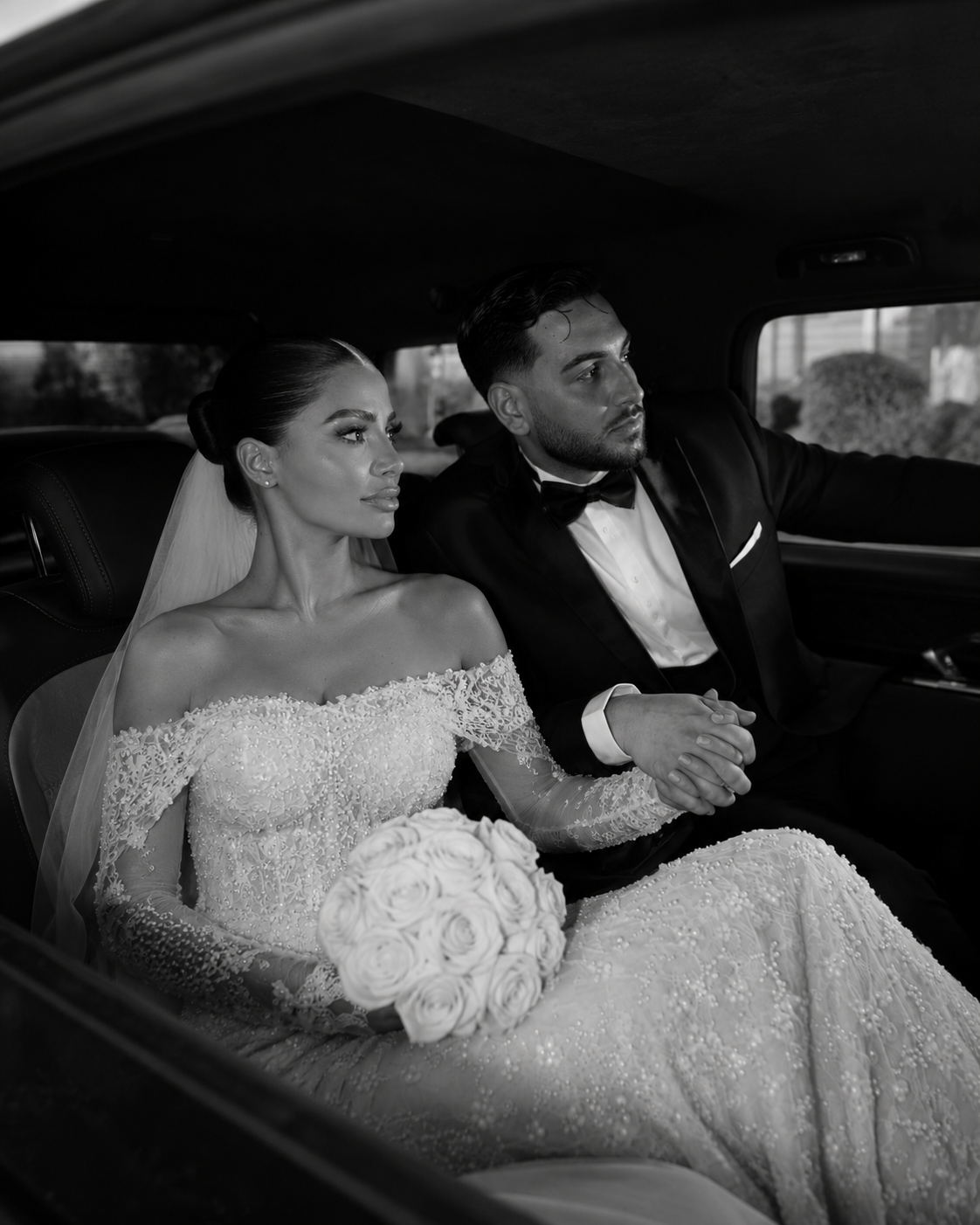 Bride and groom seated in a car